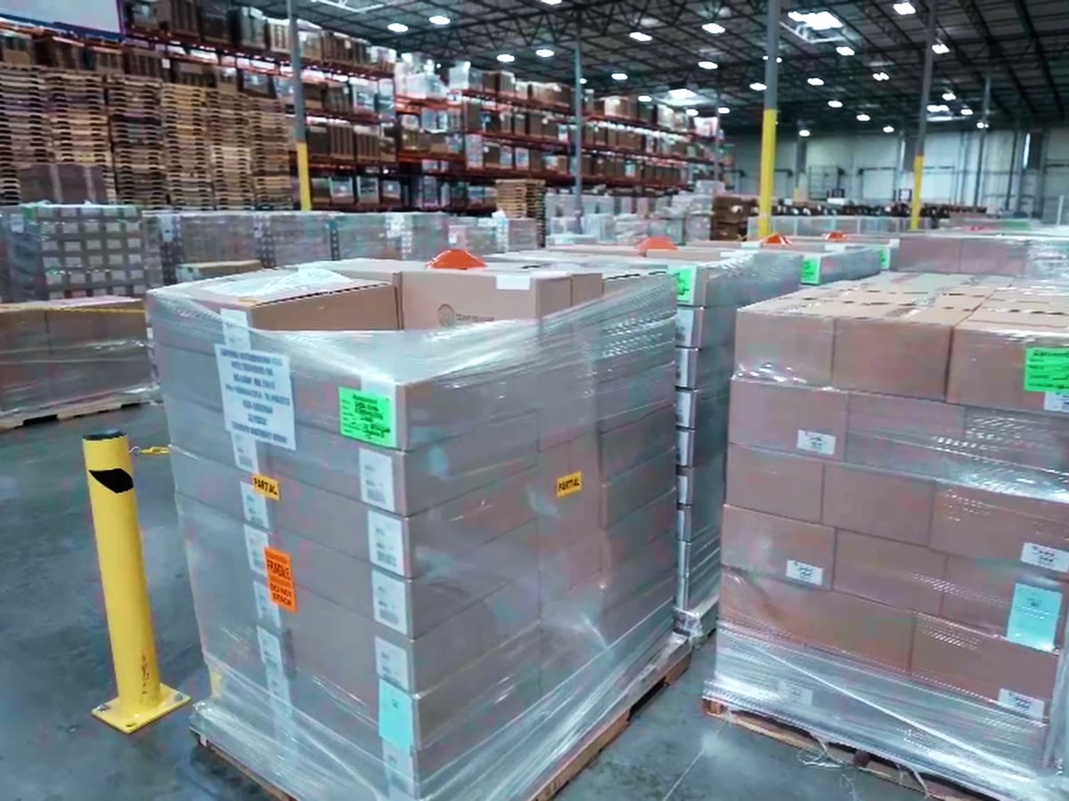Retail-ready pallets with GS1 case labels, pallet tags, and handling stickers staged for shipment