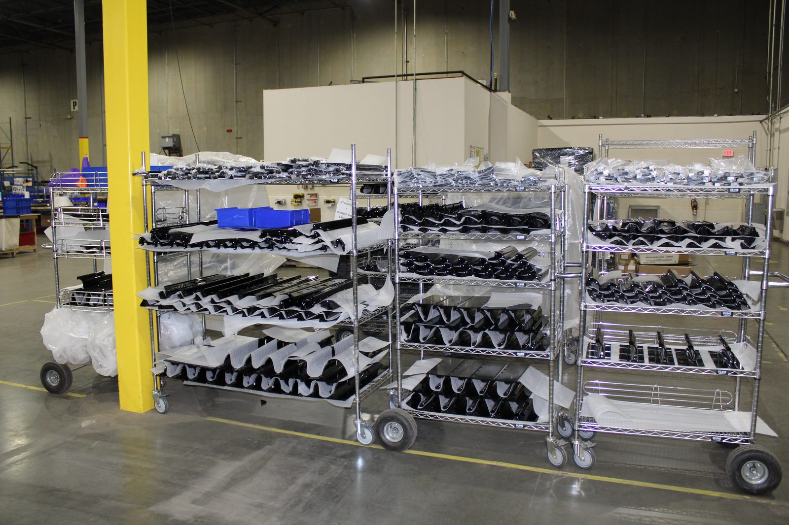 Wire shelving carts with components staged for kitting and assembly at Productiv Charlotte